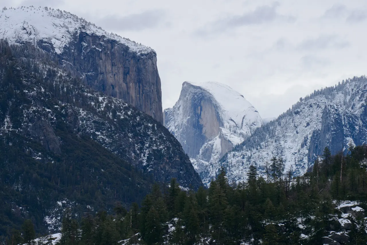 Half Dome and Yosemite Valley layered with winter snow